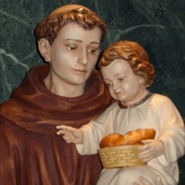 Saint holding child with bread basket statue.