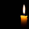 a candle lighting on the dark background