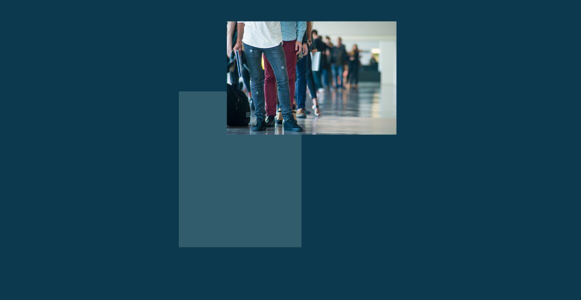People standing in a line indoors.