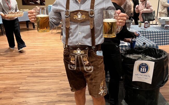 a man posing with two glasses of beer