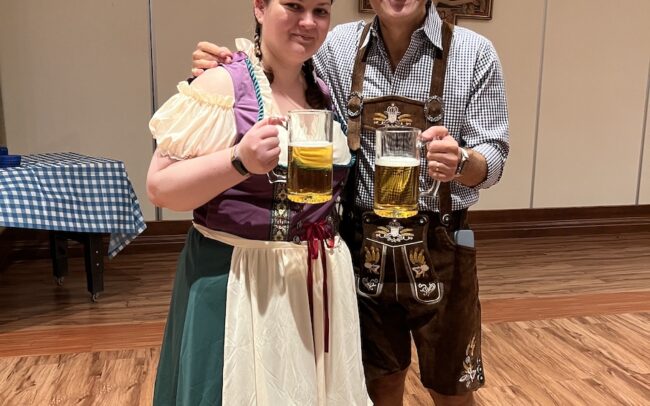 a man and woman with glasses of beer