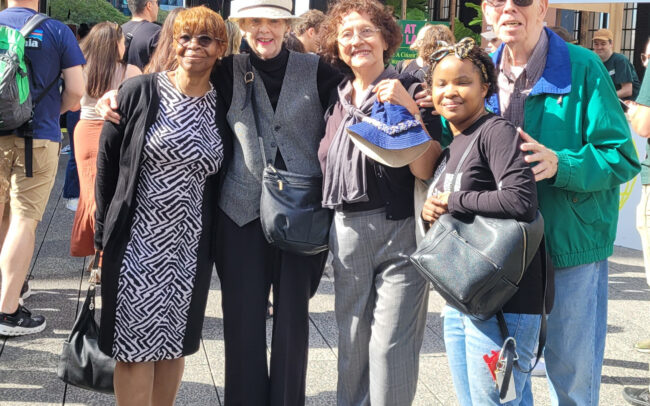 Group photo from the Laudato Si High Line walk. Five people standing in front of the Emerson Collective Climate Science Fair entrance.