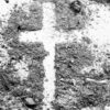 A cross outlined in dirt on the ground.